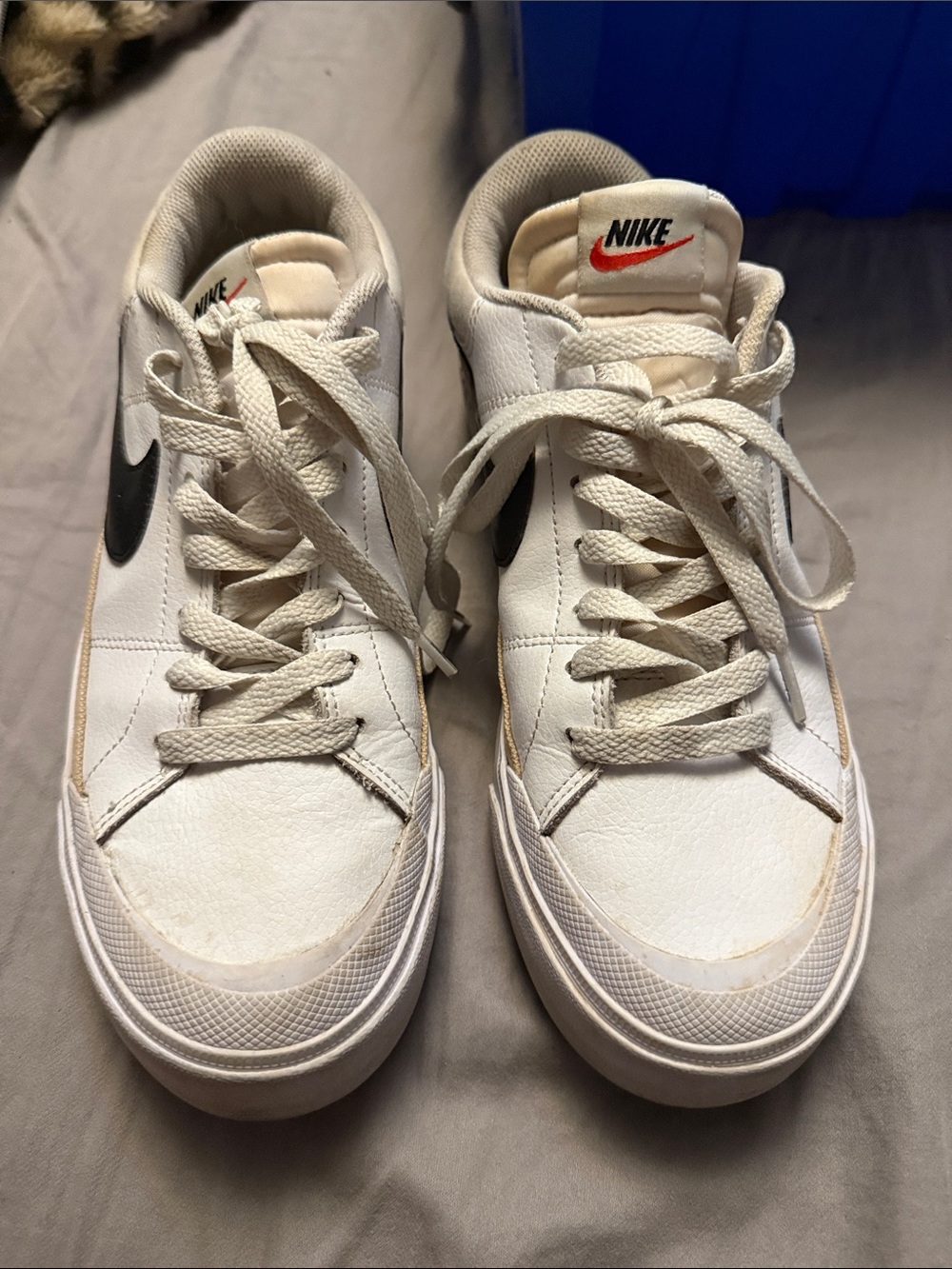 Nike White Low-Top Sneakers with Black Swoosh and Red Logo